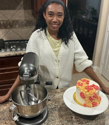 a woman in a white sweater and a cake on a counter