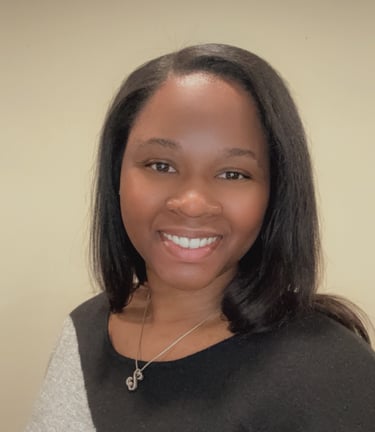 Professional headshot of Rashaye Harris, Operations Specialist smiling and w