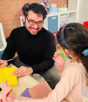 BCT Owner Constantinos Kokkinos providing expressive therapy in office at PlayWell Brooklyn