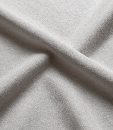 Modern automotive textile fabric in dark tones, showing weave pattern and texture.