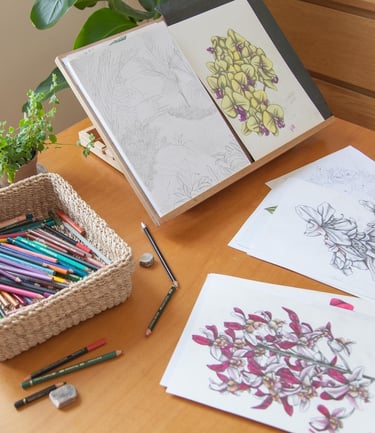 A desk with pencils and hand-drawn floral illustrations