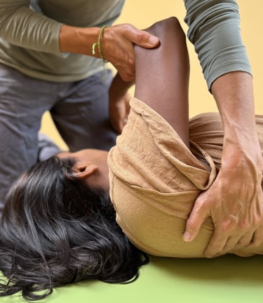 a woman is being gently moved in an individual Functional Integration session