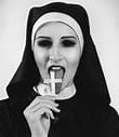 black and white photo of nun licking a crucifix 