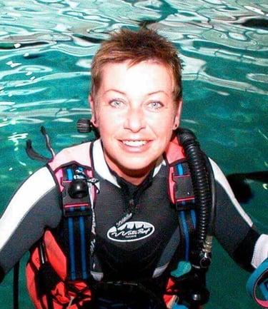 a woman in a diving suit and scuba gear