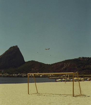 a soccer goalie on a beach with a plane flying over it