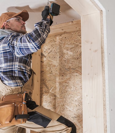 General contractor making repairs on a wall.
