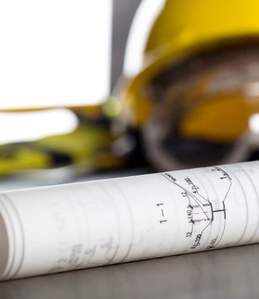 General contractor hard hat and floor plans.
