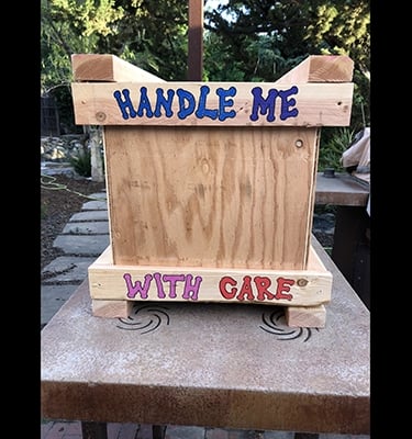 Handle Me With Care drawn on the bottom of a shipping crate.