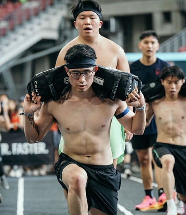 a man is carrying weighted bag during Hyrox