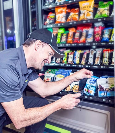 Employee servicing vending machine