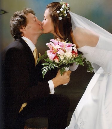 a bride and groom kissing in a wedding photo