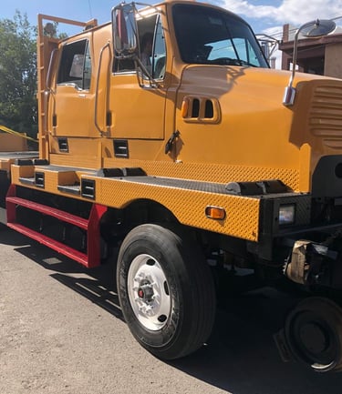 a yellow crane truck with a crane on it