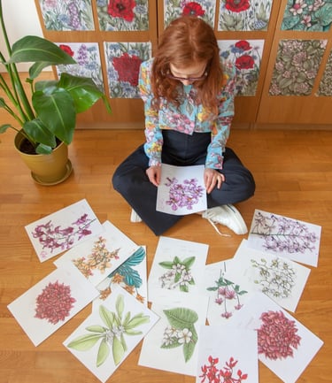 A woman sat on the floor surrounded by floral illustrations