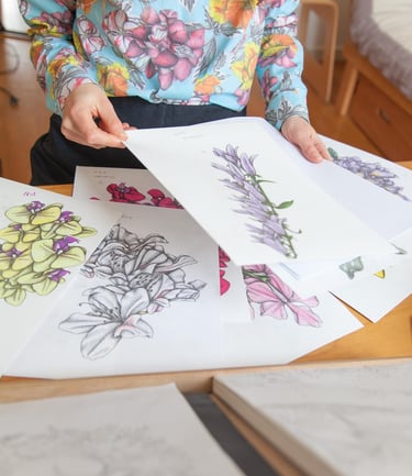 A desk filled with botanical illustrations
