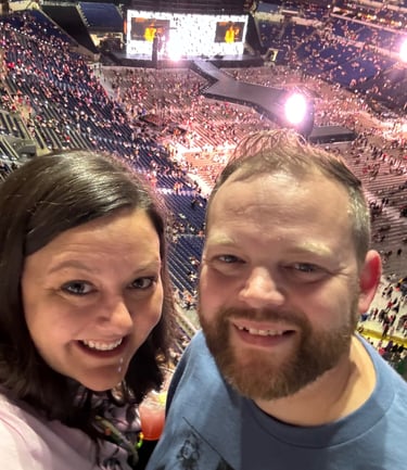 A husband and wife smiling at a Taylor Swift concert