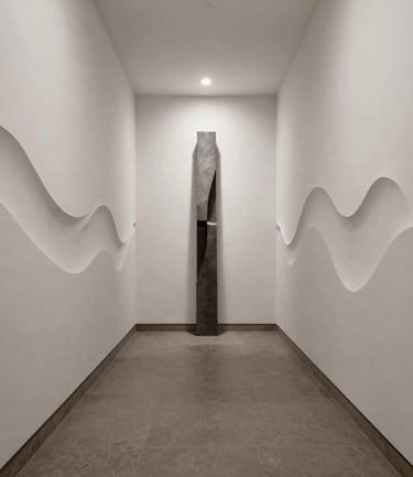 Modern minimalist black metal staircase with a thin metal handrail against a white wall.