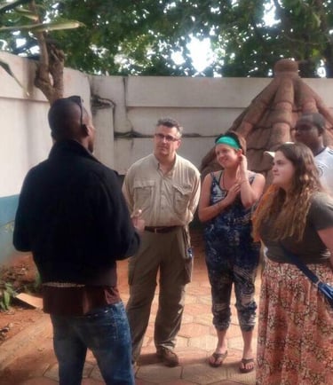 Dahomey African Tours Guide leading tourists in Pythons Temple in Benin