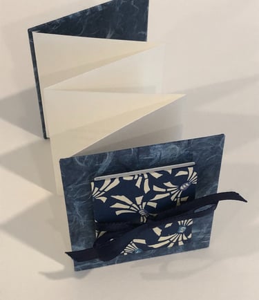 Accordion with Japanese paper and small accordion on cover, ribbon detail