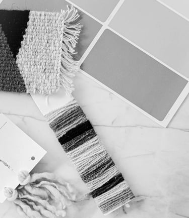 Black and white image of textile samples with varying textures and a monochromatic color palette.