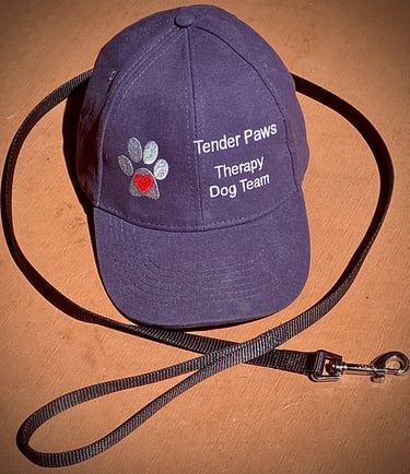Blue Tender Paws Therapy Dog Team cap with a leash.
