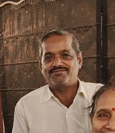 a man and woman standing in front of a wall