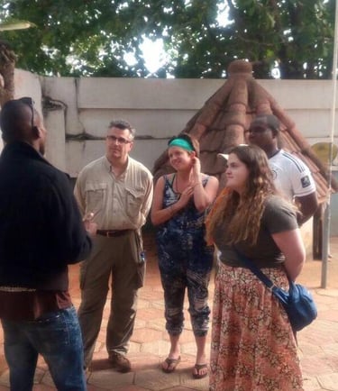 Dahomey African Tours Guide leading tourists in Pythons Temple in Benin