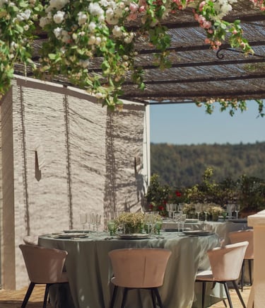 Outdoor dining table under vines at Finca Santa Katerina