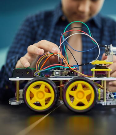 a girl is holding a arduino car