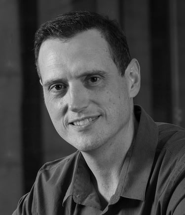 a man in a black shirt and a cell phone