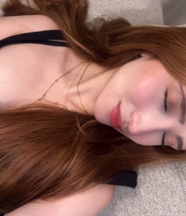 a woman with long hair and a black bra