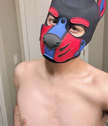 Man with bare chest in pup mask.