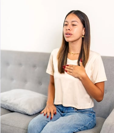 a woman sitting on a couch with a remote control