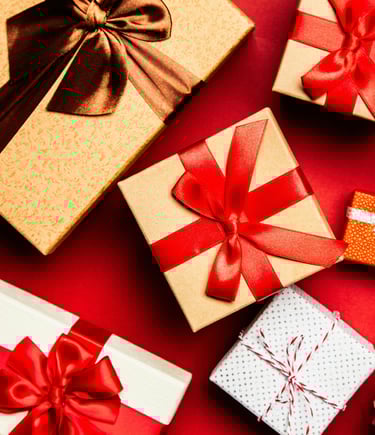 a bunch of gift boxes with bows on a red background