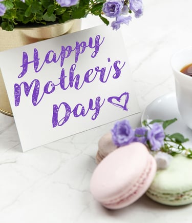 a cup of coffee and a card saying happy mothers day