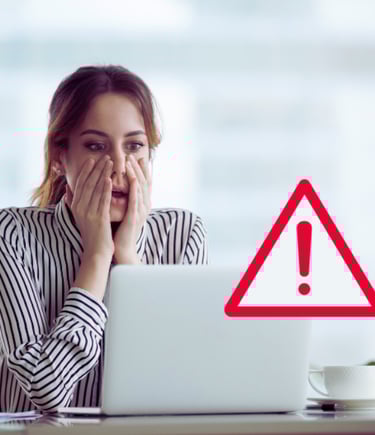 a woman with a laptop computer and a warning sign
