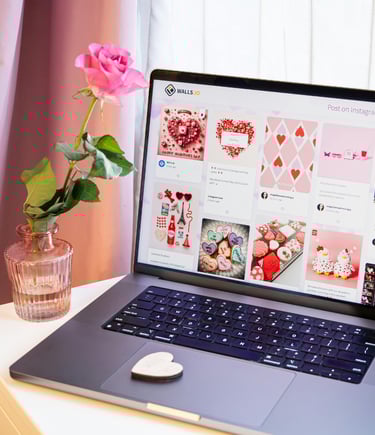 a laptop screen showing valentines day pictures and a flower