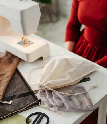 a woman in red dress is sitting infront of table with sewing table
