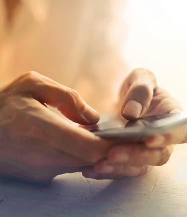 a person holding a cell phone in their hands
