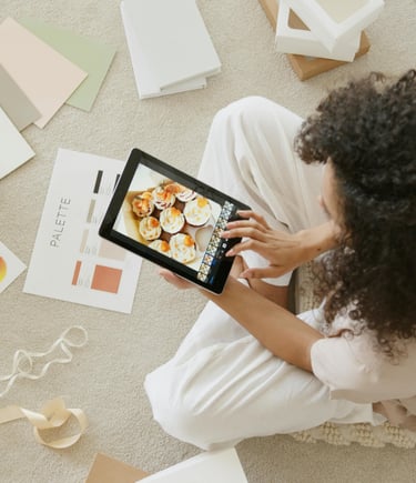 a woman sitting on a rug with a tablet