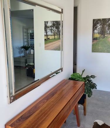 square mirror in entrance above table