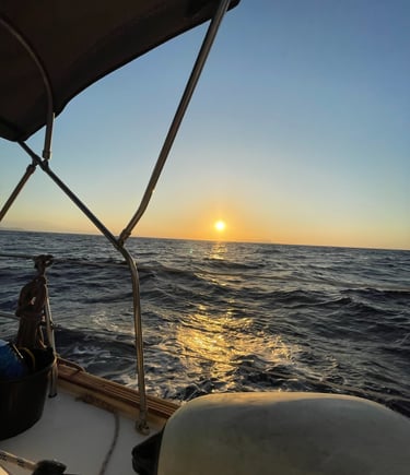 a man sitting on a boat in the ocean
