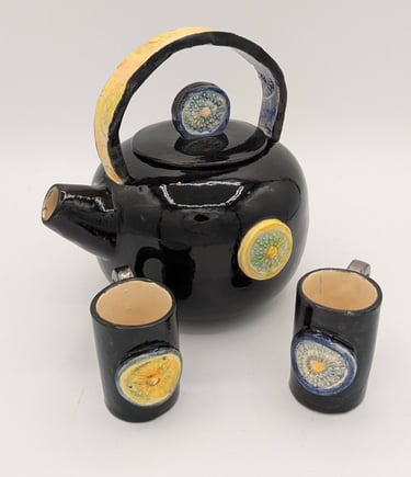 a teapot with a teapot and cups, moon, sun finial, ceremony