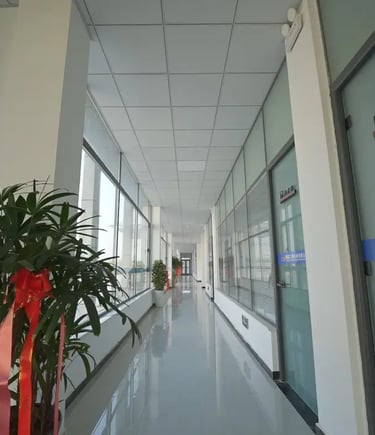 Zorulift Construction Machinery: Bright, modern office corridor to Manufacturing Dept. Clean, professional.