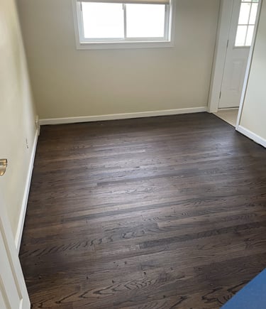 Dark walnut stained oak refinished hardwood floors with a natural wood grain texture.