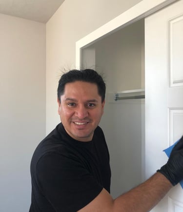 a man in black gloves and gloves is holding a blue glove