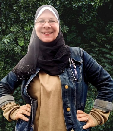 a woman wearing a hijab and smiling
