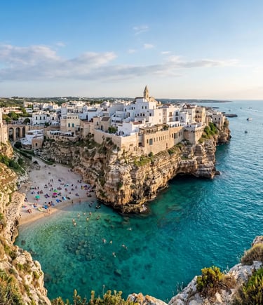 Panoramic view of Polignano a Mare white houses on limestone cliffs above turquoise Adriatic Sea