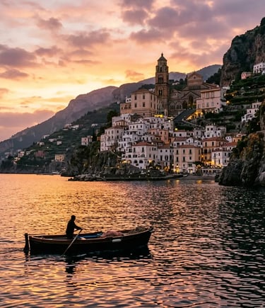 Amalfi village and cathedral seen from the sea at sunset with small boat silhouette
