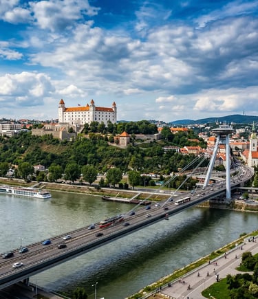 Bratislava Castle on hilltop above Danube River with UFO Bridge and city skyline below