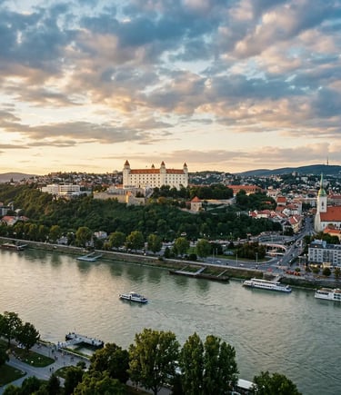 Aerial view of Bratislava Castle on a hill above the Danube River at sunset